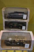 Three boxed military vehicles.