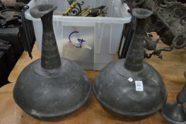 A pair of pewter ewers.