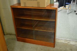 Modern bookcase with sliding glass doors.