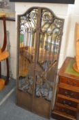 An unusual wrought iron framed gate style mirror.