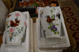 A pair of porcelain vases decorated with butterflies and flowers with original boxes.