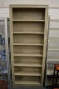 An Oka green painted free standing bookcase.