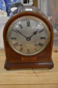 A mahogany mantle clock.