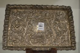 An embossed silver dressing table tray.