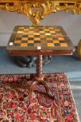 A rosewood, ebony and specimen wood games table, the square shaped top supported on a barley twist