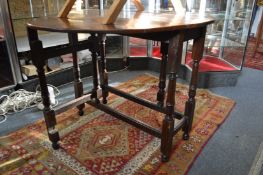An oak drop leaf gateleg dining table.