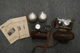 A Leica 35mm camera with leather case and accessories to include lenses, instruction books etc.