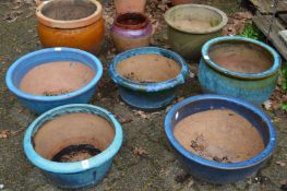 A quantity of glazed plant pots.