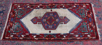 A Persian rug, pale cream ground central panel with geometric decoration 6'3