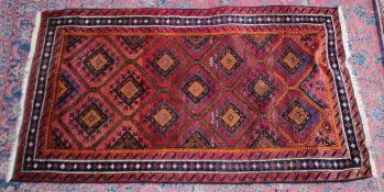 A Persian design rug, pink ground with geometric panels 6'6