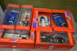 Six boxed Porsche racing cars.