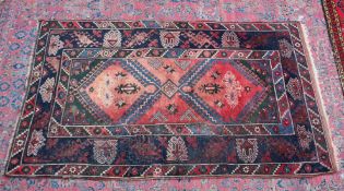 A Persian carpet, pale pink central ground stylised geometric decoration 6'7