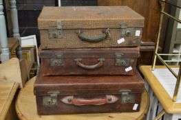 Three leather suitcases.
