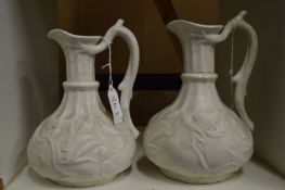 A pair of moulded jugs.