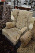 A Georgian design wing armchair on cabriole legs.