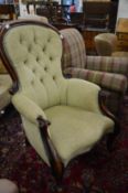 A large Victorian mahogany framed button upholstered armchair.