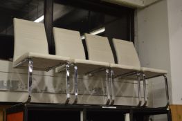 A set of four chrome framed dining chairs.