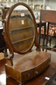 A mahogany bow fronted dressing table mirror.