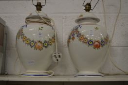 A large pair of floral decorated lamp bases.