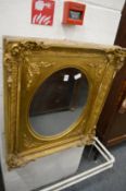 An ornate gilt framed mirror.