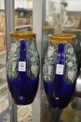 A pair of Royal Doulton vases, one cracked.