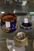 A Doulton match striker and two small frilly edge vases.