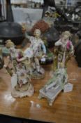 Four decorative porcelain figurines.