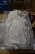 A silk christening gown, other white lace and linen.