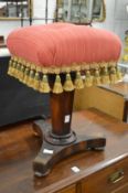 A rosewood music stool.