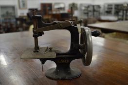 A miniature Singer sewing machine.