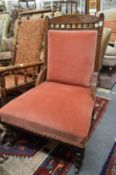 A Victorian oak framed and upholstered chair.
