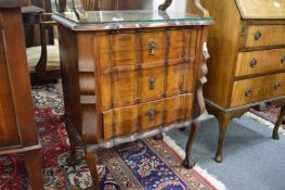 A Continental walnut three drawer chest.