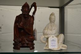 Chinese carved wood figure of a seated deity together with a blanc de chine figure of a seated