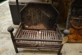 Cast iron fire grate with integral cast iron back.