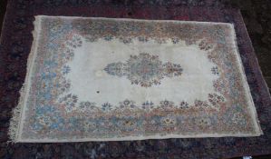 An Indian carpet, cream ground with floral decoration 9'3