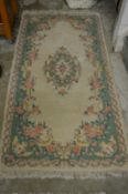 A cream ground floral decorated Indian rug 6ft x 3ft.