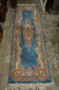 A blue ground floral runner 7ft x 2ft 3