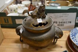 A large Chinese lidded bronze censer with elephant head handles.