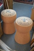 A pair of novelty bar stools modelled as champagne corks.