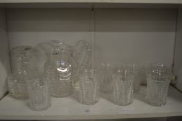 A good Stuart cut glass jug with six tumblers together with a matching decanter and smaller