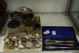 A small collection of silverware to include mugs, cruets etc.