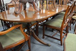 A Georgian style mahogany twin pillar dining table with one leaf.