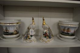 A pair of colourful porcelain peacocks and a pair of jardinieres decorated with sailing ships.