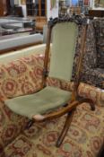 A Victorian walnut folding chair.