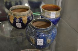 Three small Royal Doulton bowls or vases.