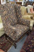 A large oak framed wing armchair.
