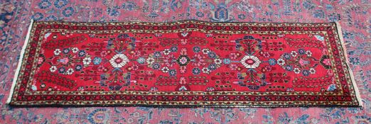 A Persian runner, bright red ground with stylised floral design 6'8