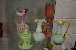 Three frilly edged opaque glass jugs and two other items.