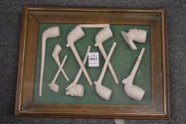 A display case containing a quantity of clay pipes.