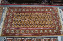 A modern Bokhara rug, beige ground with three rows of fifteen gulls 5'4